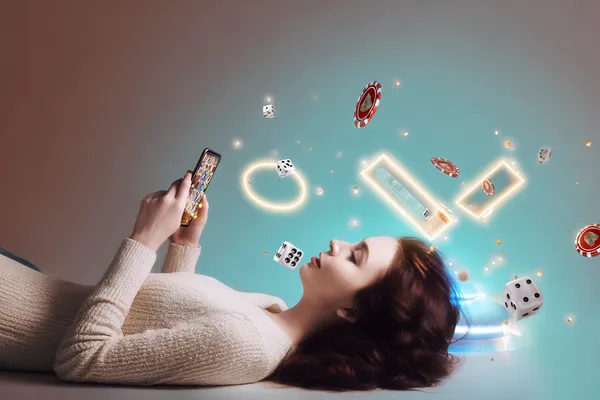 A young woman relaxing with her phone while dynamic casino elements float around her, illustrating the smooth mobile experience offered by the CD33 app.